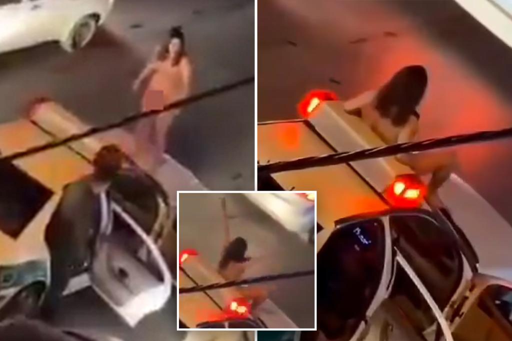 Video shows naked Iranian woman jumping on police car in protest at country’s treatment of women