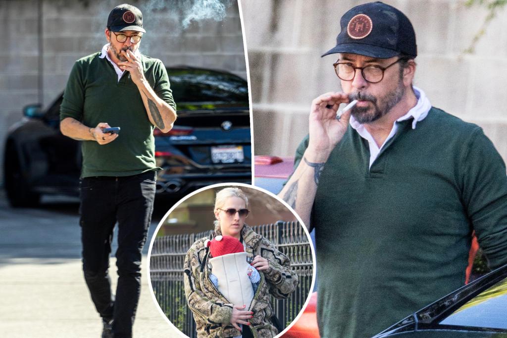 Dave Grohl puffs on a cigarette, appears stressed after mother of his secret love child is revealed