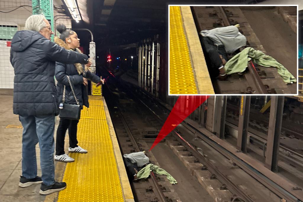 NYC straphangers flag down help for incoherent man lying on tracks — moments before incoming train was due to arrive